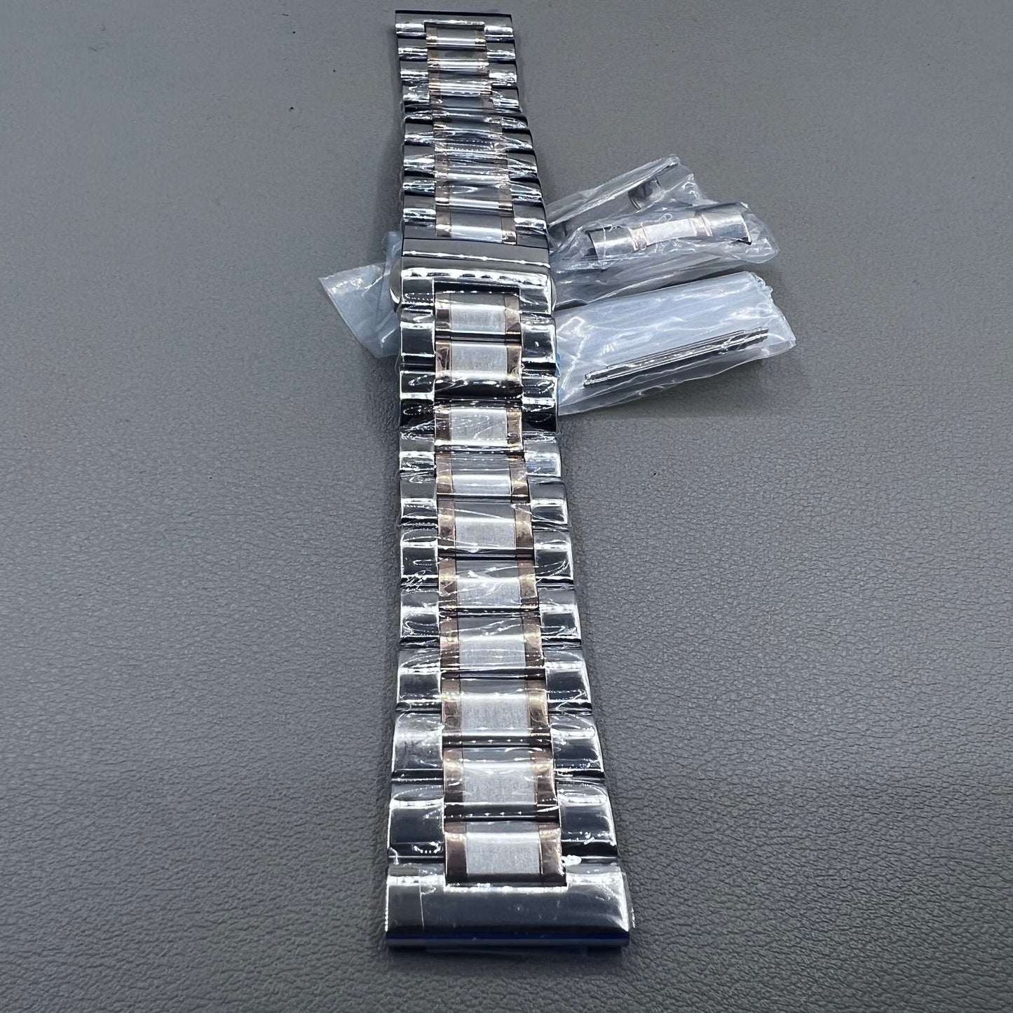 Curved end 12-24mm steel watch band strap in rose gold and silver with butterfly clasp.