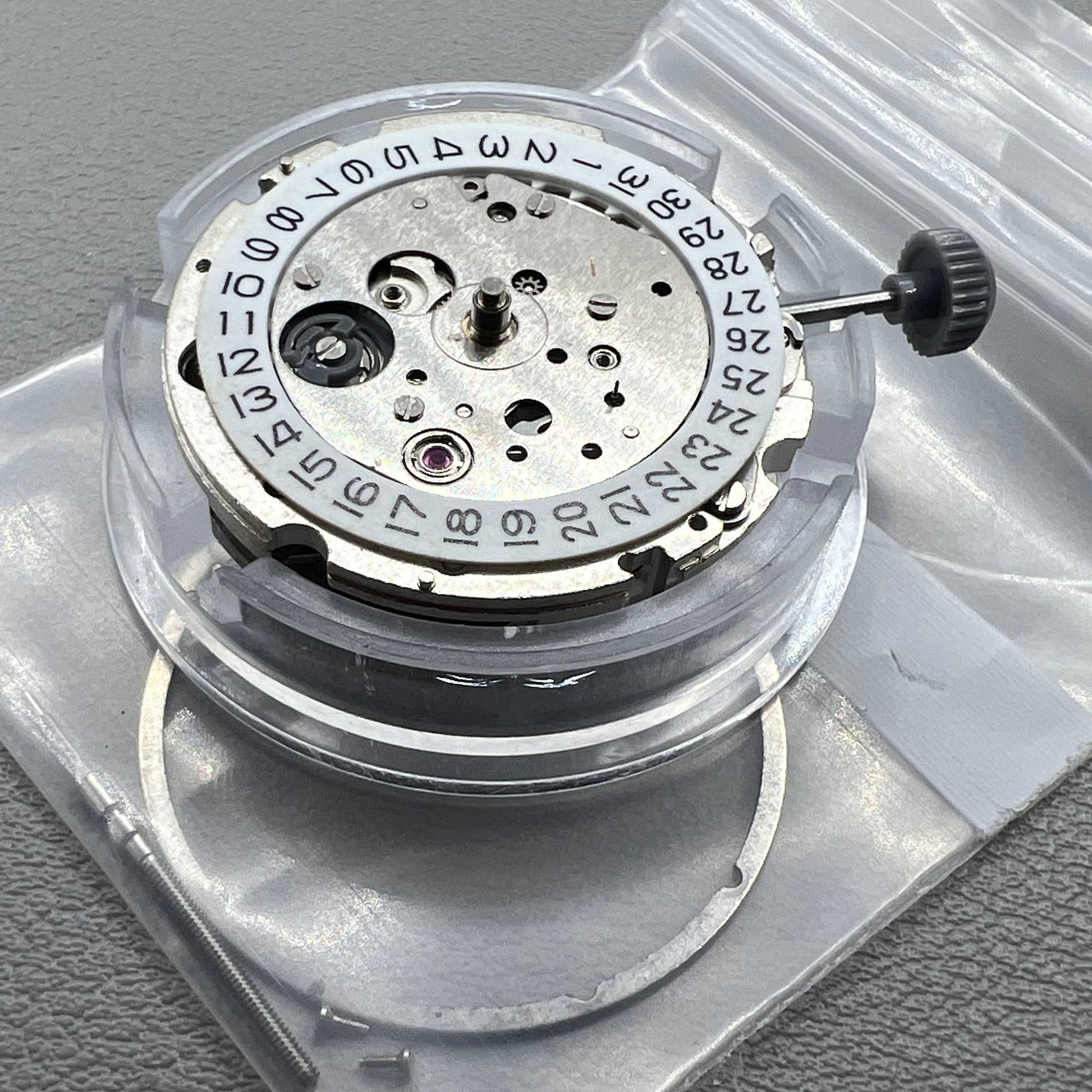Japan Miyota 8218 automatic watch movement with date at 9 o'clock and two hands, precision timekeeping.