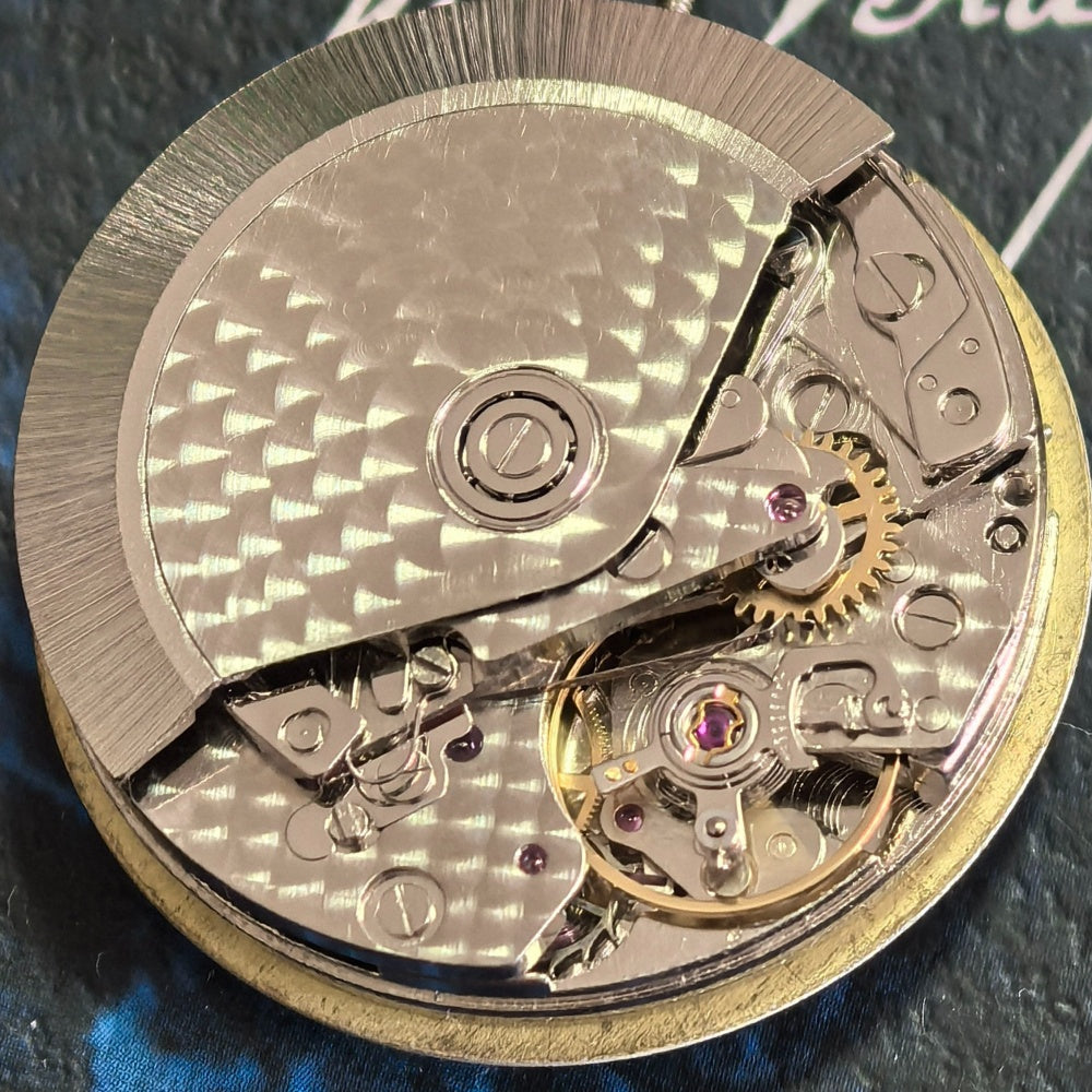 Chinese Dandong 7750 mechanical watch featuring single calendar and tri-subdial design at 6, 9, and 12 o'clock positions.