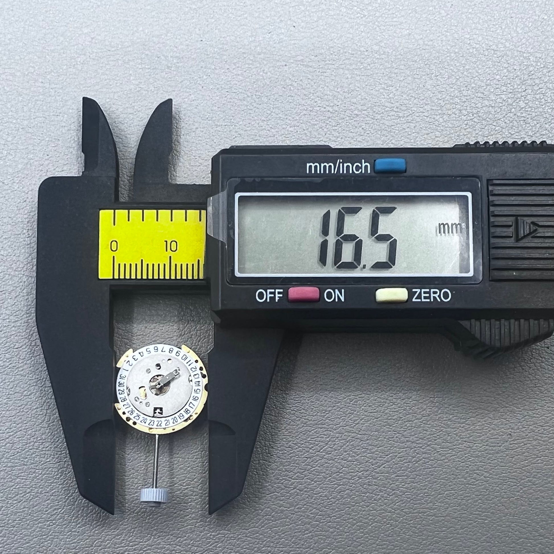 Swiss Ronda 775 quartz watch part with white date disk at 6 o'clock, ideal for precise repairs.