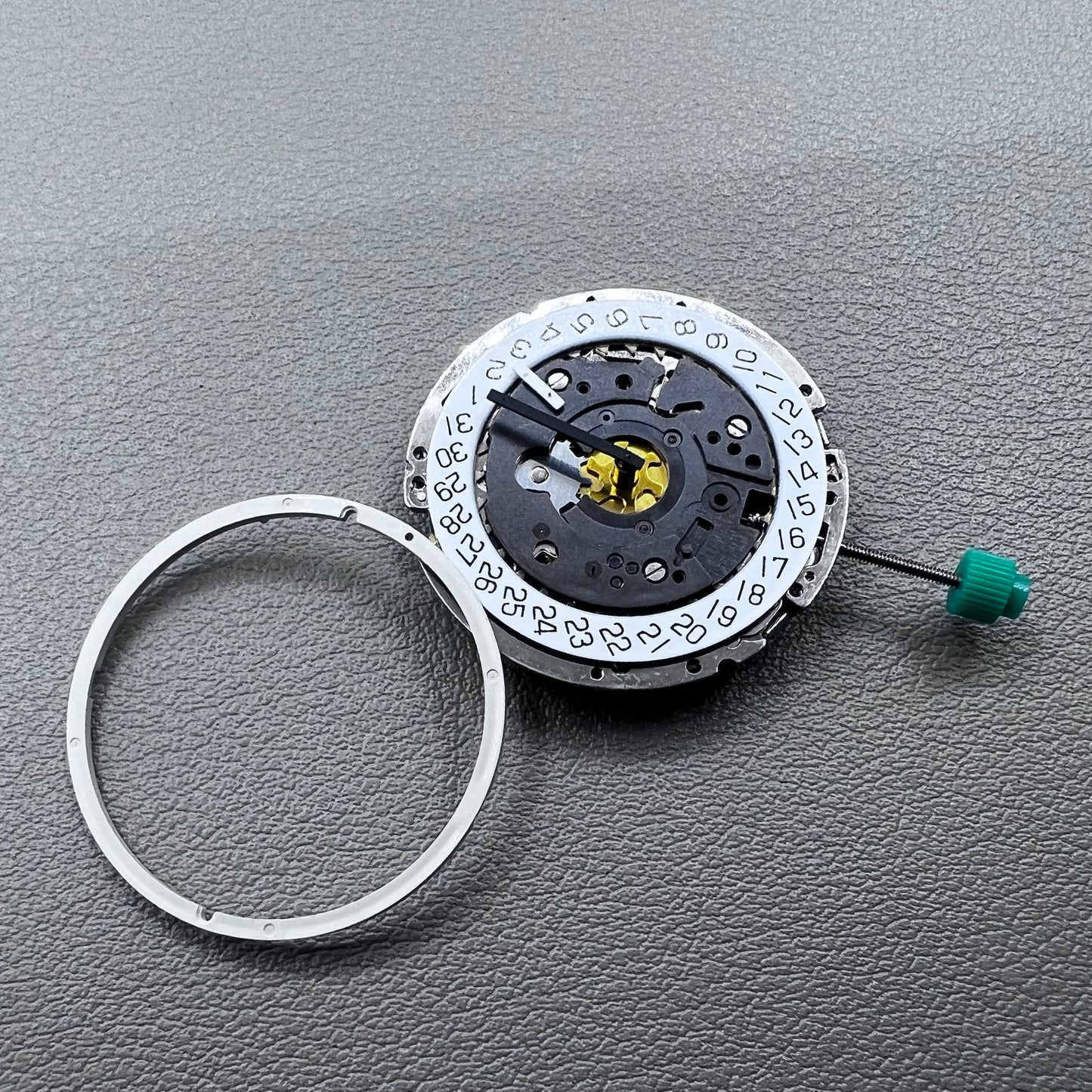Swiss ISA 8172 silver plated quartz watch movement with stem, precise timekeeping for watch repair and assembly.