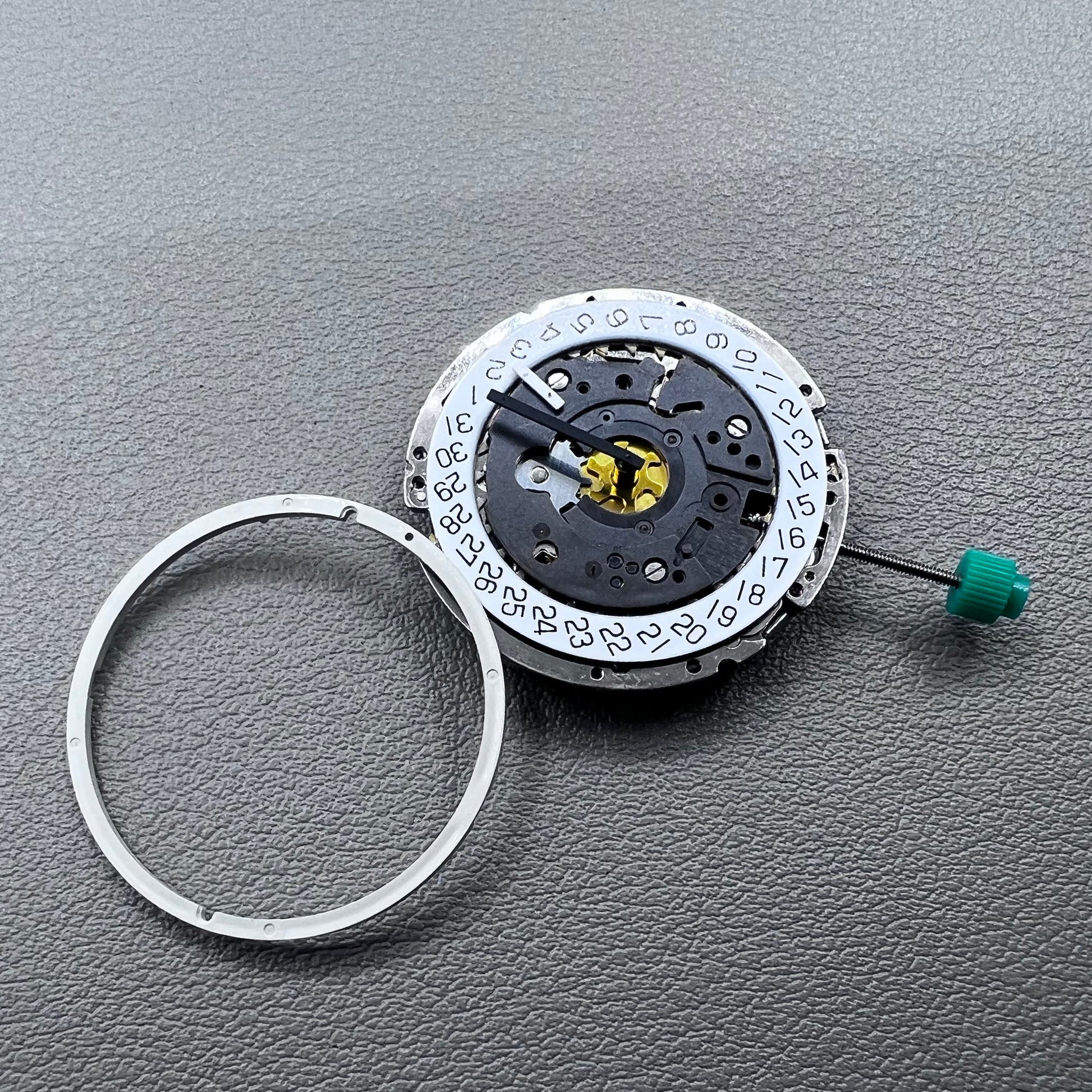 Swiss ISA 8172 silver plated quartz watch movement with stem, precise timekeeping for watch repair and assembly.