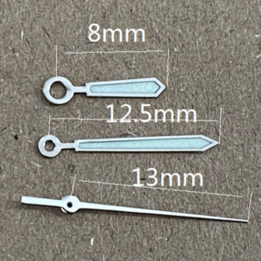 Silver-trimmed green lume watch hands for Ronda 515 quartz movement, ideal for precise timekeeping.