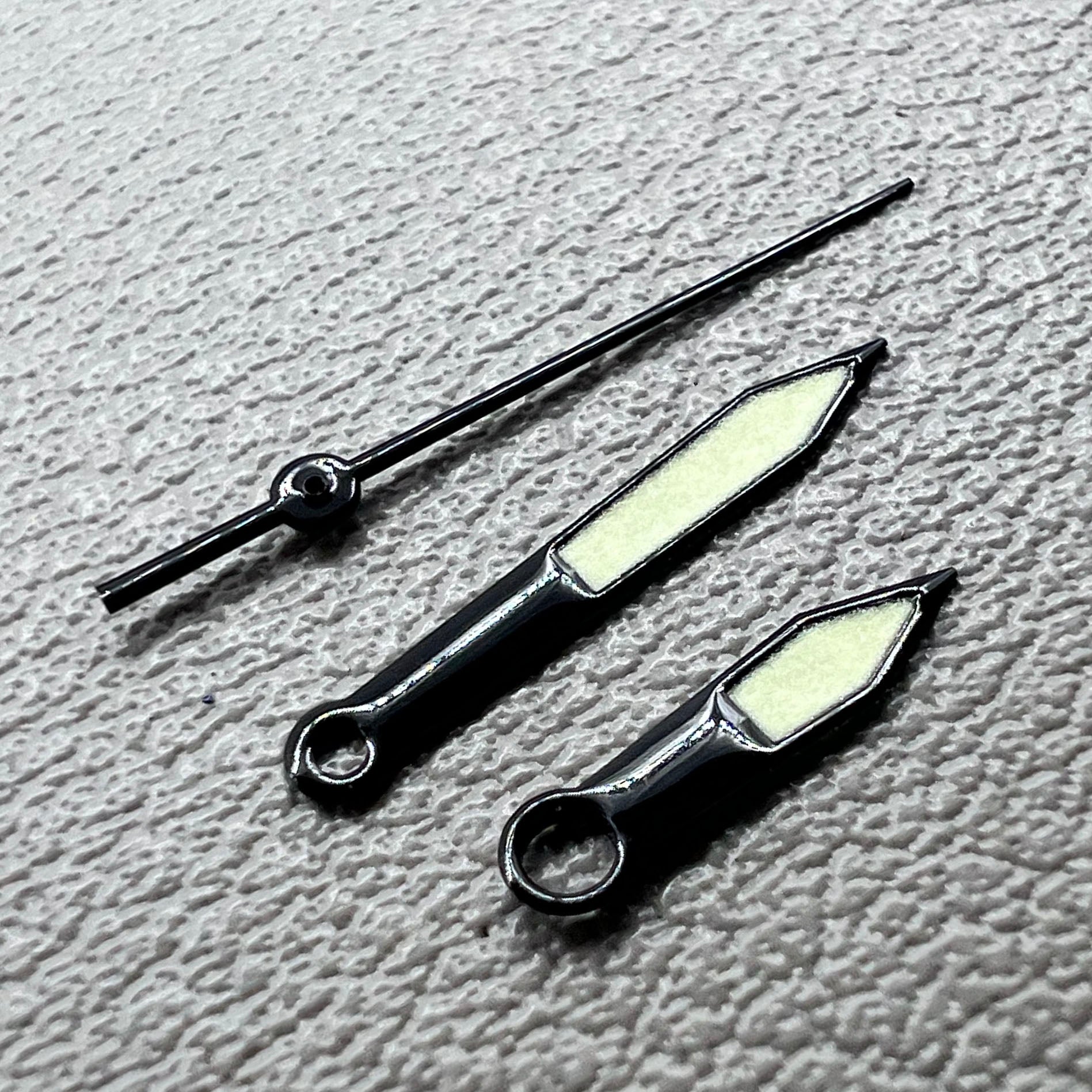 Black trim green lume watch hands set for Miyota 8215 with luminous tips, perfect for watch repairs and upgrades.