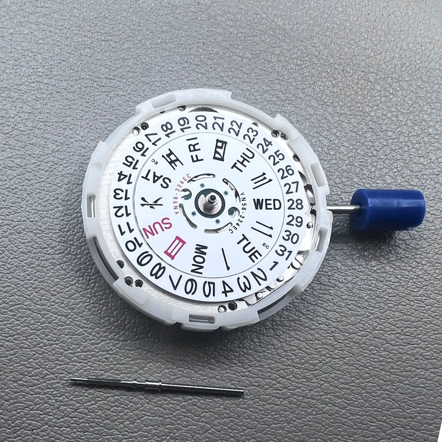 Japan Epson YN56 mechanical watch movement showing date and day display at 3 o'clock, precise and reliable.