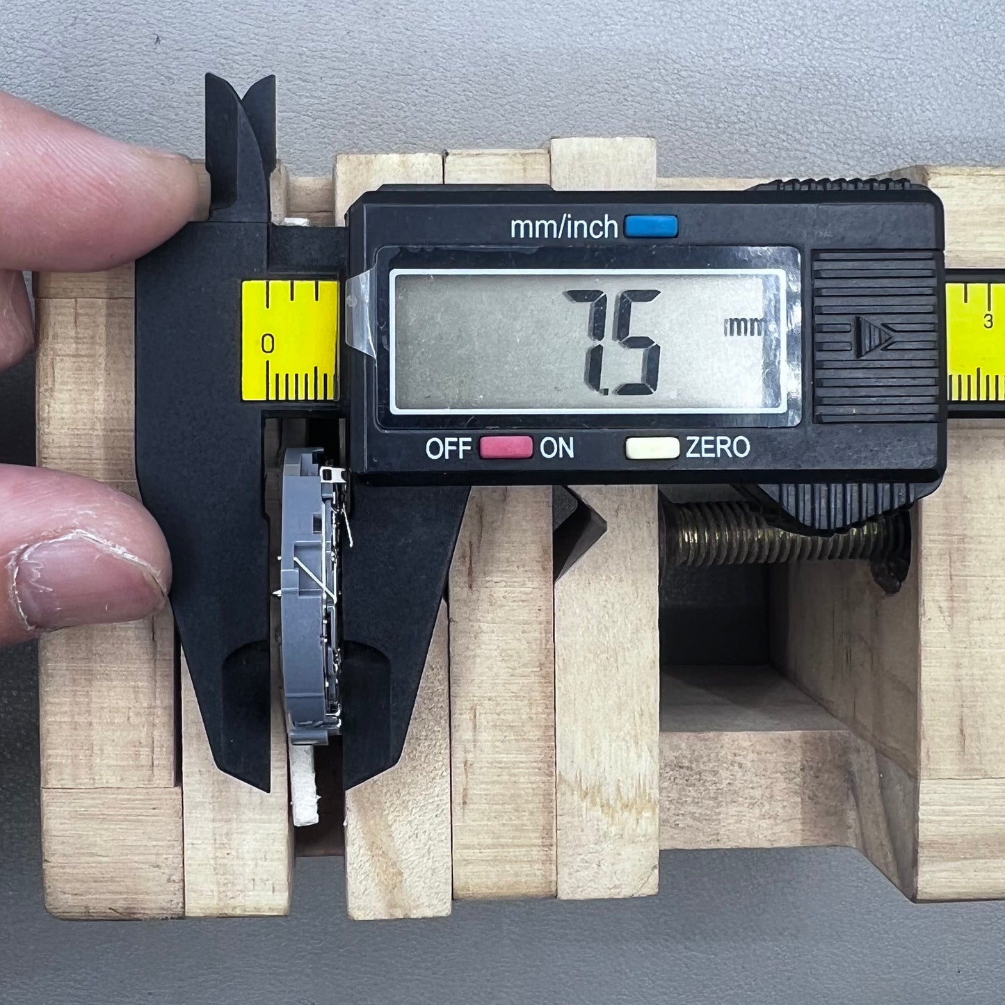 Japan Seiko VK63 quartz watch movement with black disk and white font for precise timekeeping.