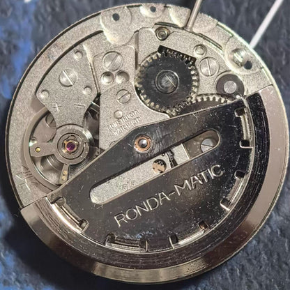 Swiss Made ETA1219 mechanical watch movement with red font, double calendar, and 3 hands for precise timekeeping.