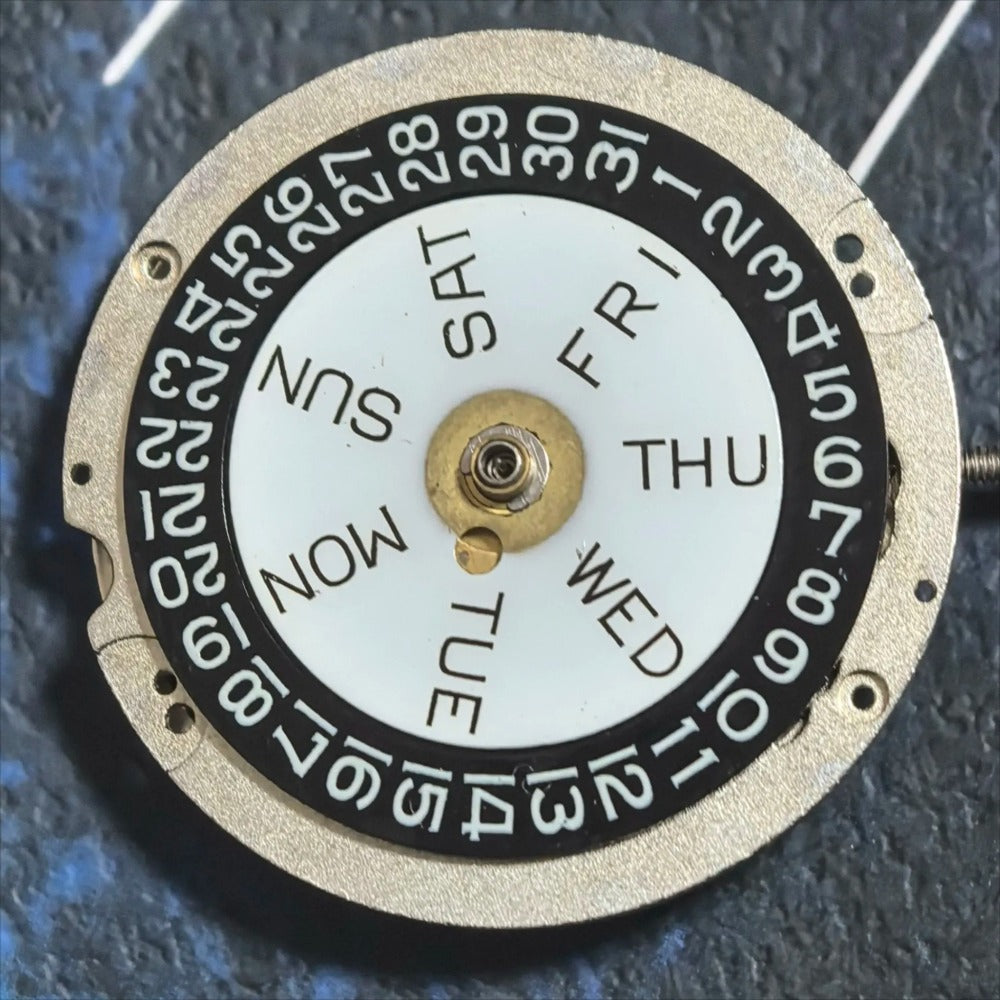 Swiss Made ETA CAL1219 watch movement with double calendar and black font hands for precise timekeeping.