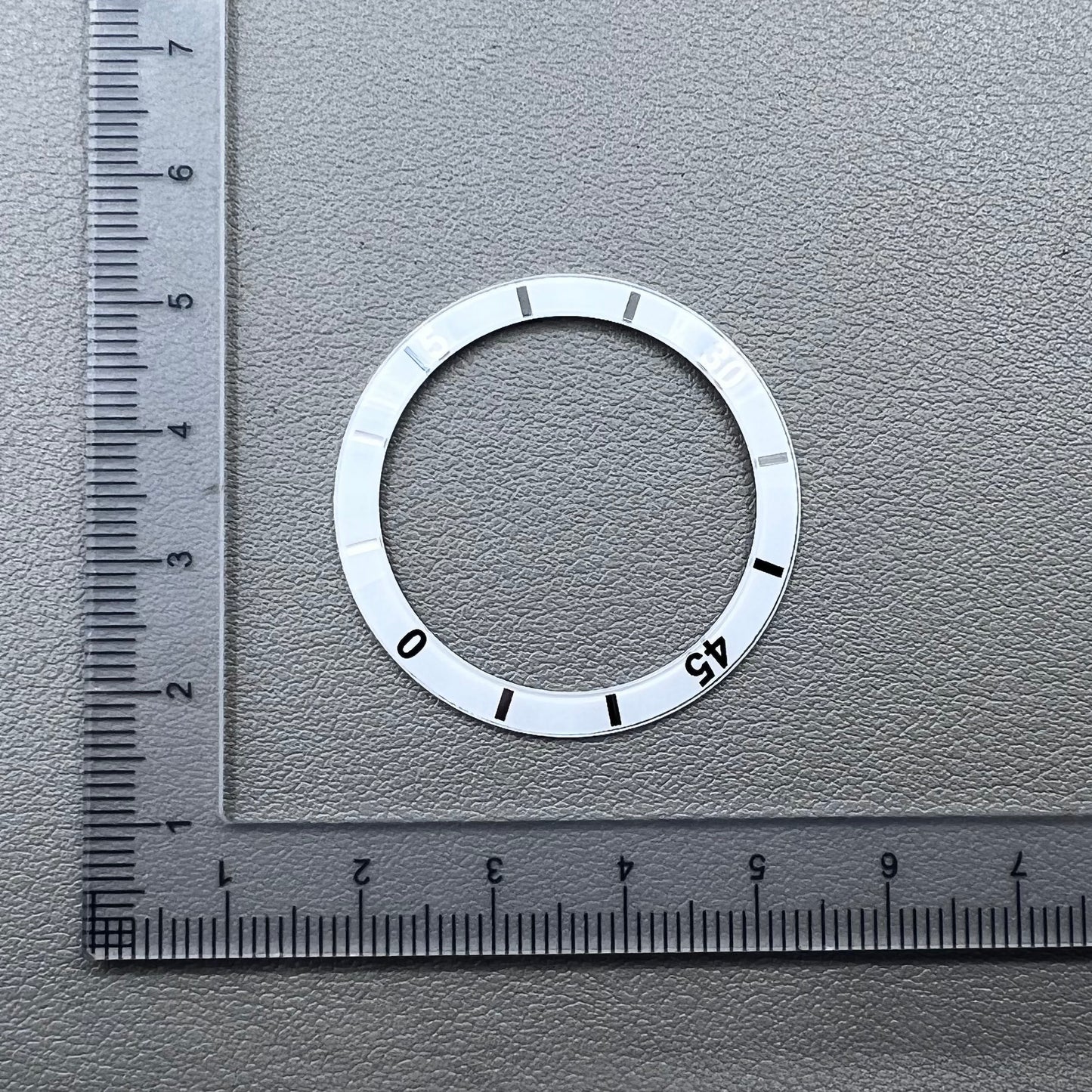White 36mm ceramic watch bezel insert with numeral markings for men's and women's watches.