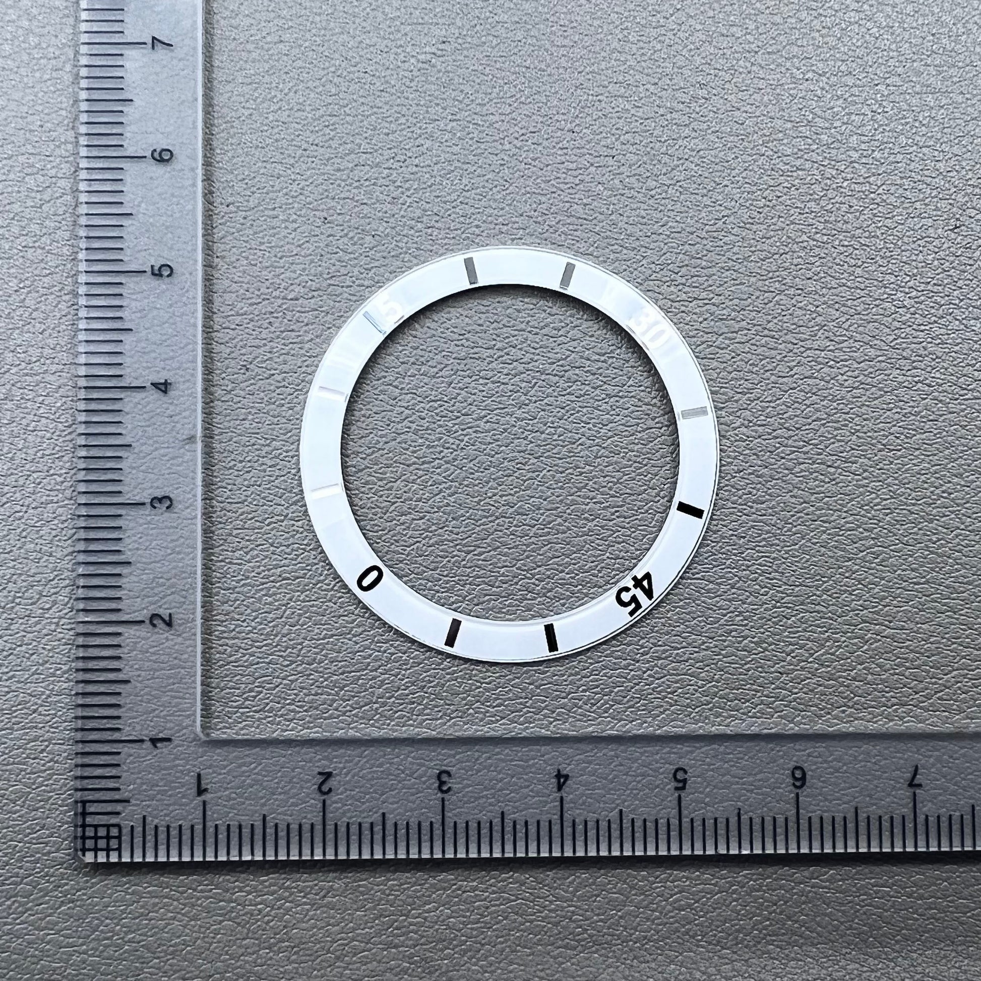 White 36mm ceramic watch bezel insert with numeral markings for men's and women's watches.