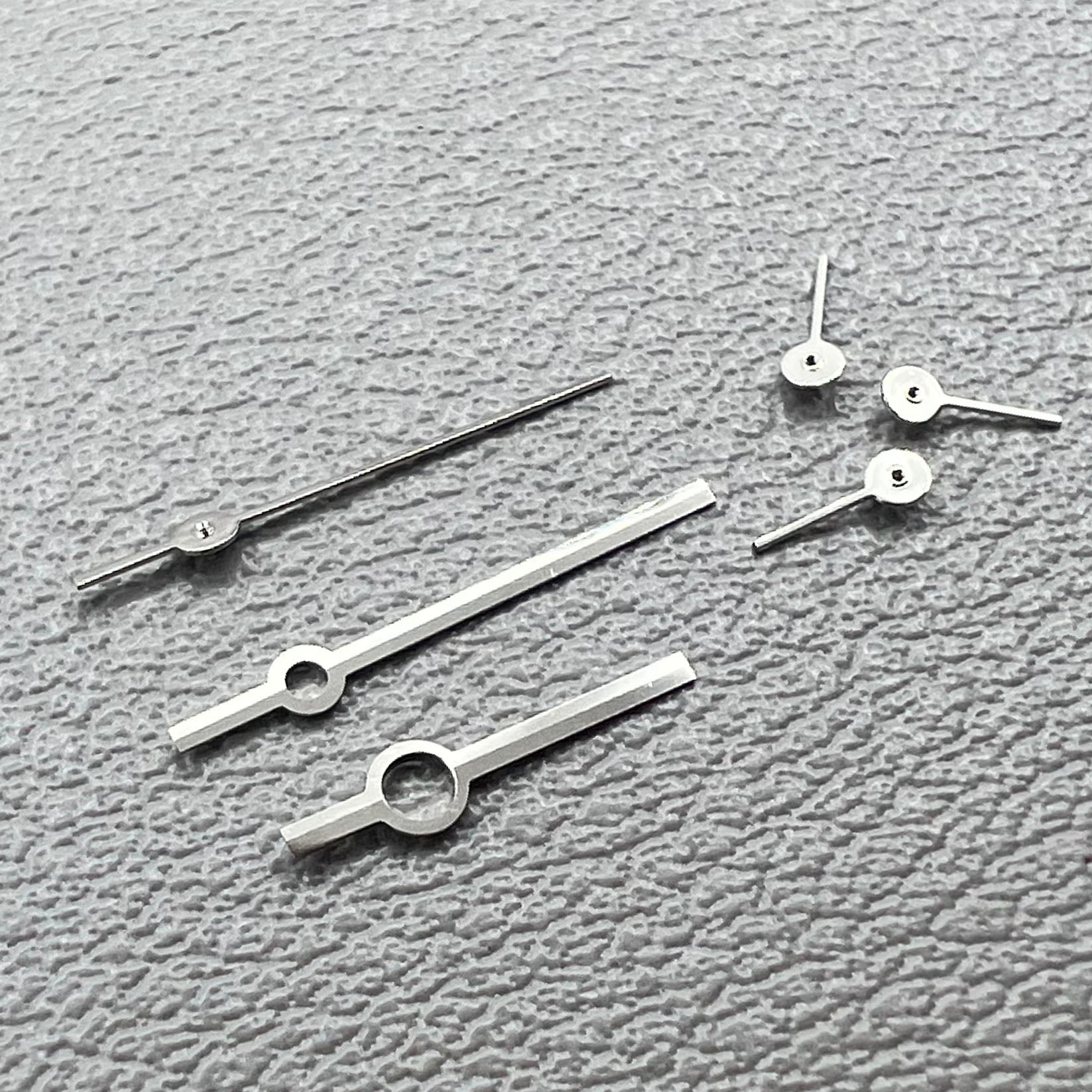 Silver watch hands set for Ronda 5030.D quartz movement, precision timepiece parts.