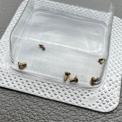 Set of 6 L4.209.4 watch case back screws, 1.2�0.7�1.7mm, for precise watch repair and maintenance.