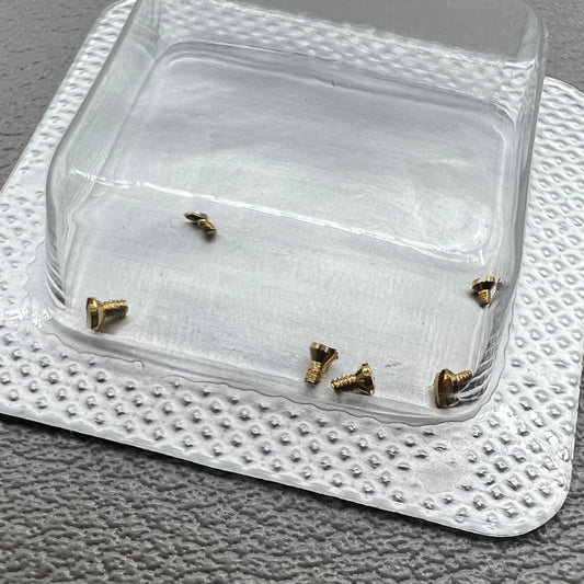 Set of 6 L4.209.4 watch case back screws, 1.2�0.7�1.7mm, for precise watch repair and maintenance.