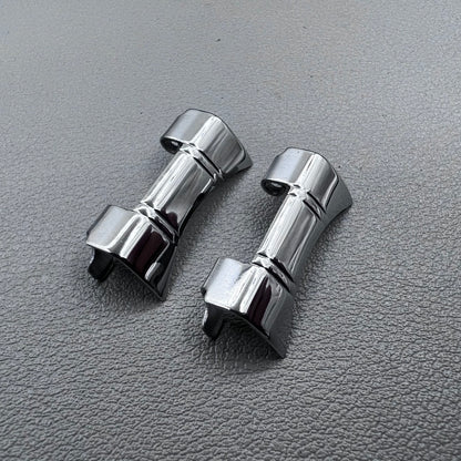 Set of 2 silver steel curved end links with spring bars for 24x12mm watch bands, enhancing bracelet fit.