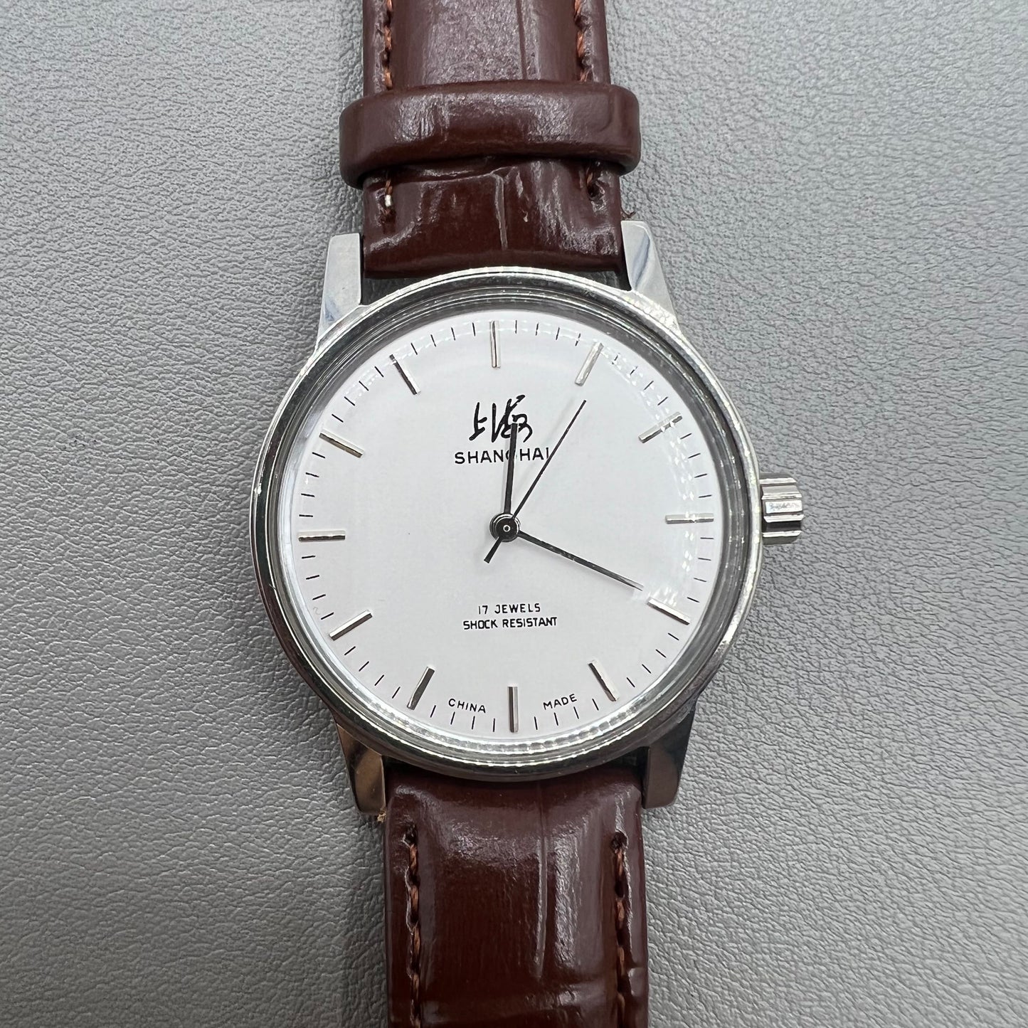 Shanghai 36mm 8120 manual mechanical watch with white dial, brown strap, 17 jewels precision craftsmanship.
