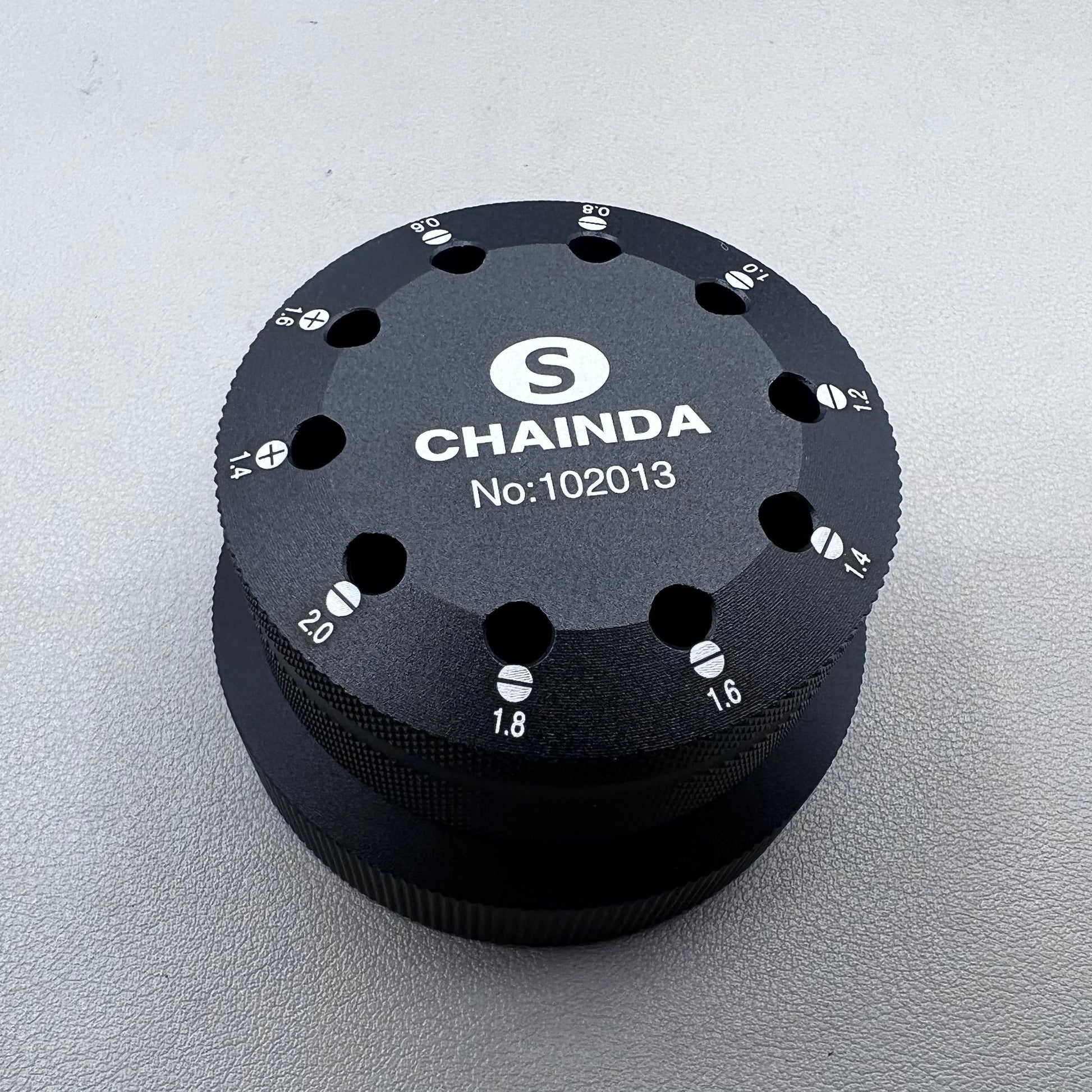 Black rotating stand with 10 slots for 0.6-2.0mm watch screwdrivers, organized storage solution.