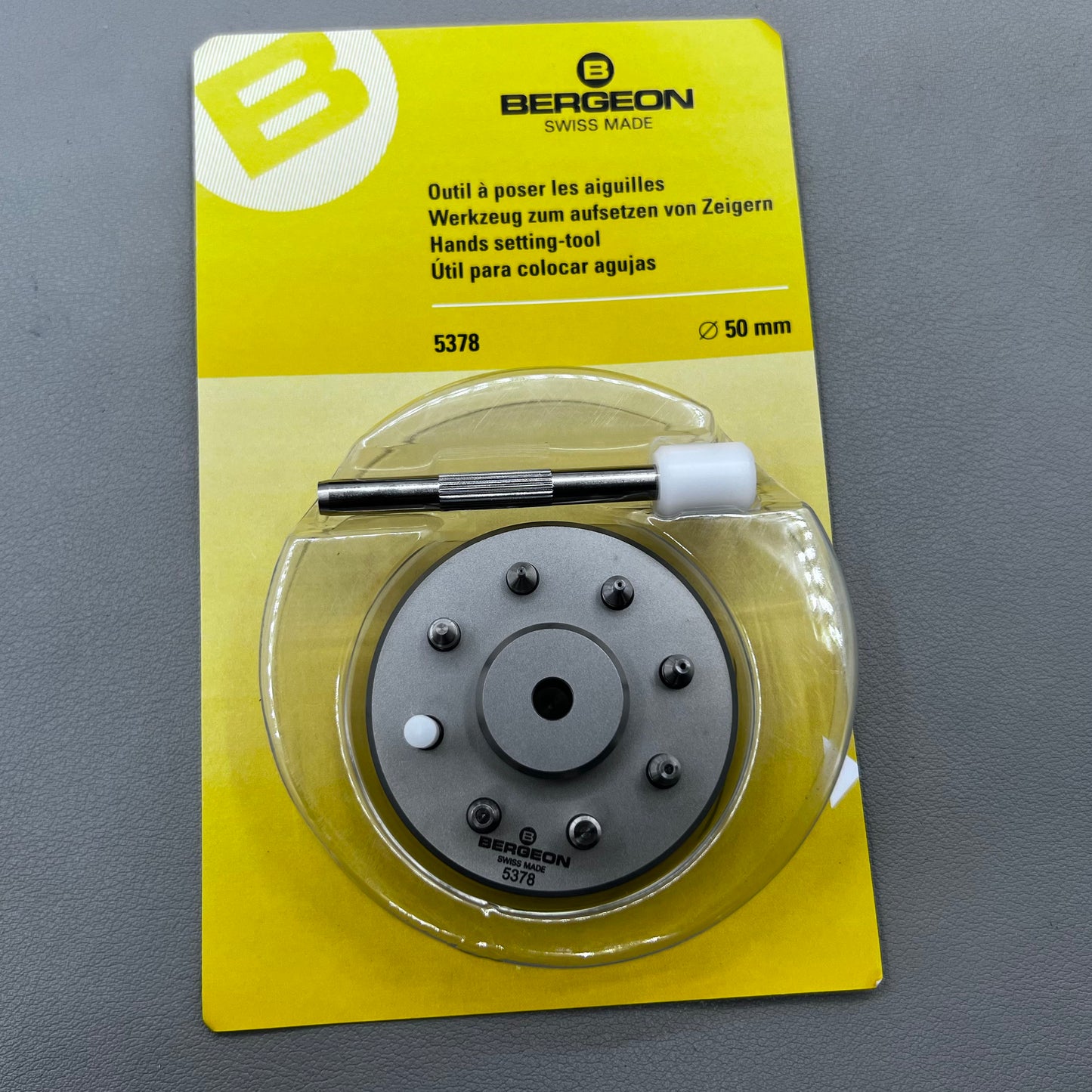 Swiss Bergeon 5378 watch hand fitting tool with 9 stakes on holder for precise hand installation.