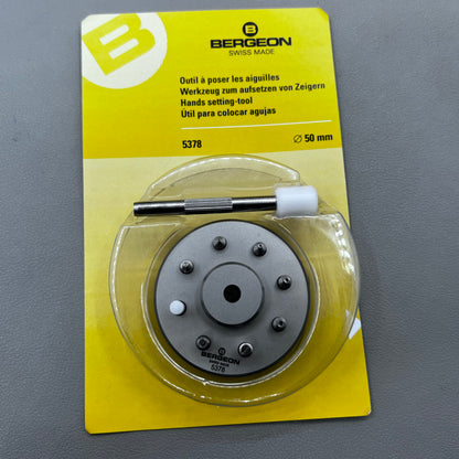 Swiss Bergeon 5378 watch hand fitting tool with 9 stakes on holder for precise hand installation.
