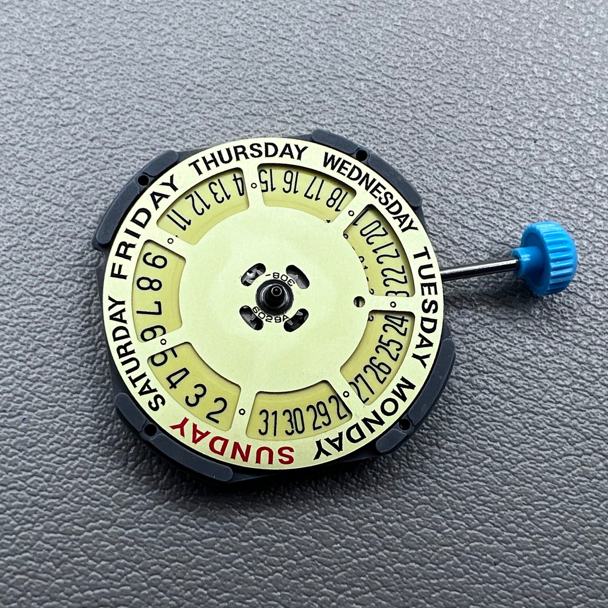 Japan Miyota 6M50 Quartz watch movement with golden dial, date at 6 o'clock, 3 hands, precise timekeeping.