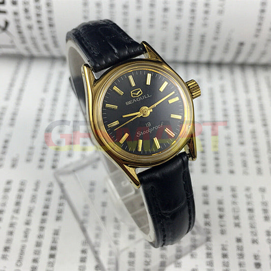 Black round case Tianjin Seagull ladies watch with gold nail markers and manual mechanical movement.