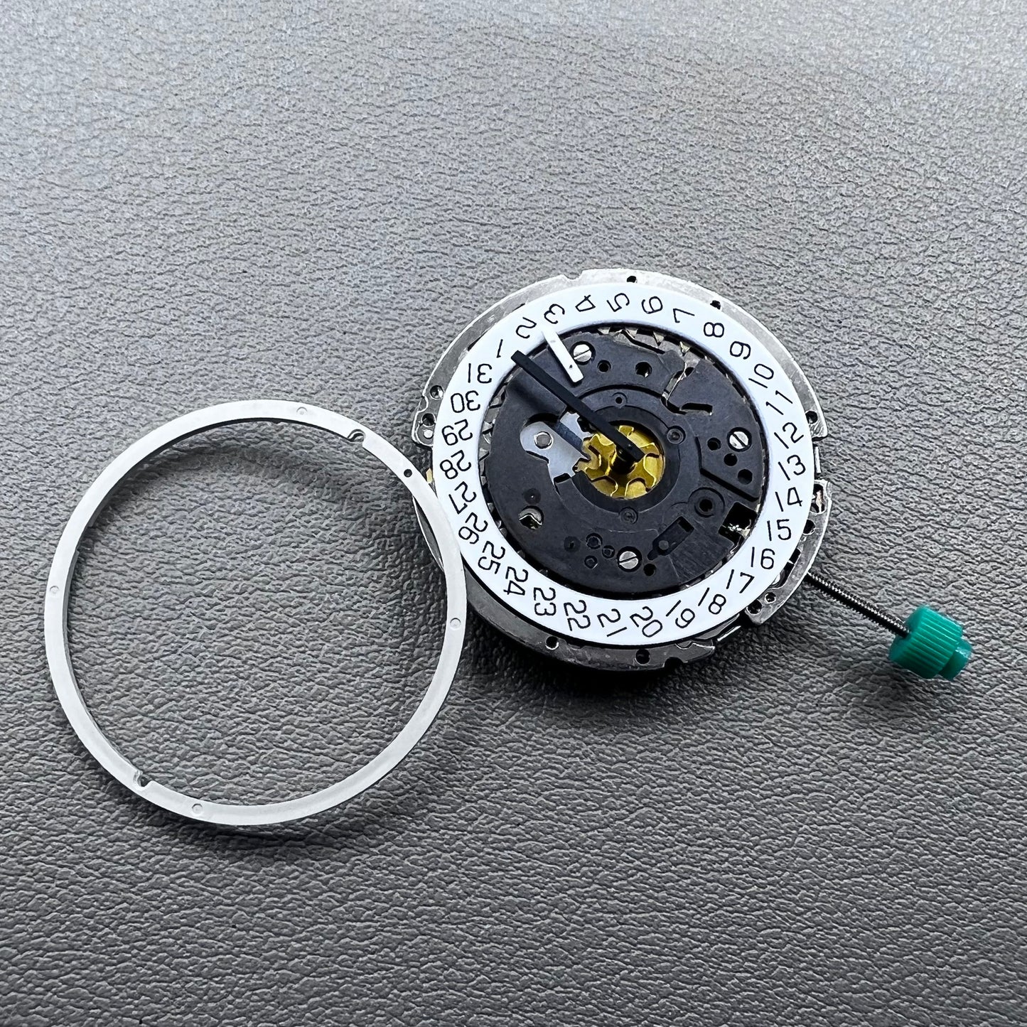 Swiss ISA 8172 silver plated quartz watch movement with stem, precise timekeeping for watch repair and assembly.