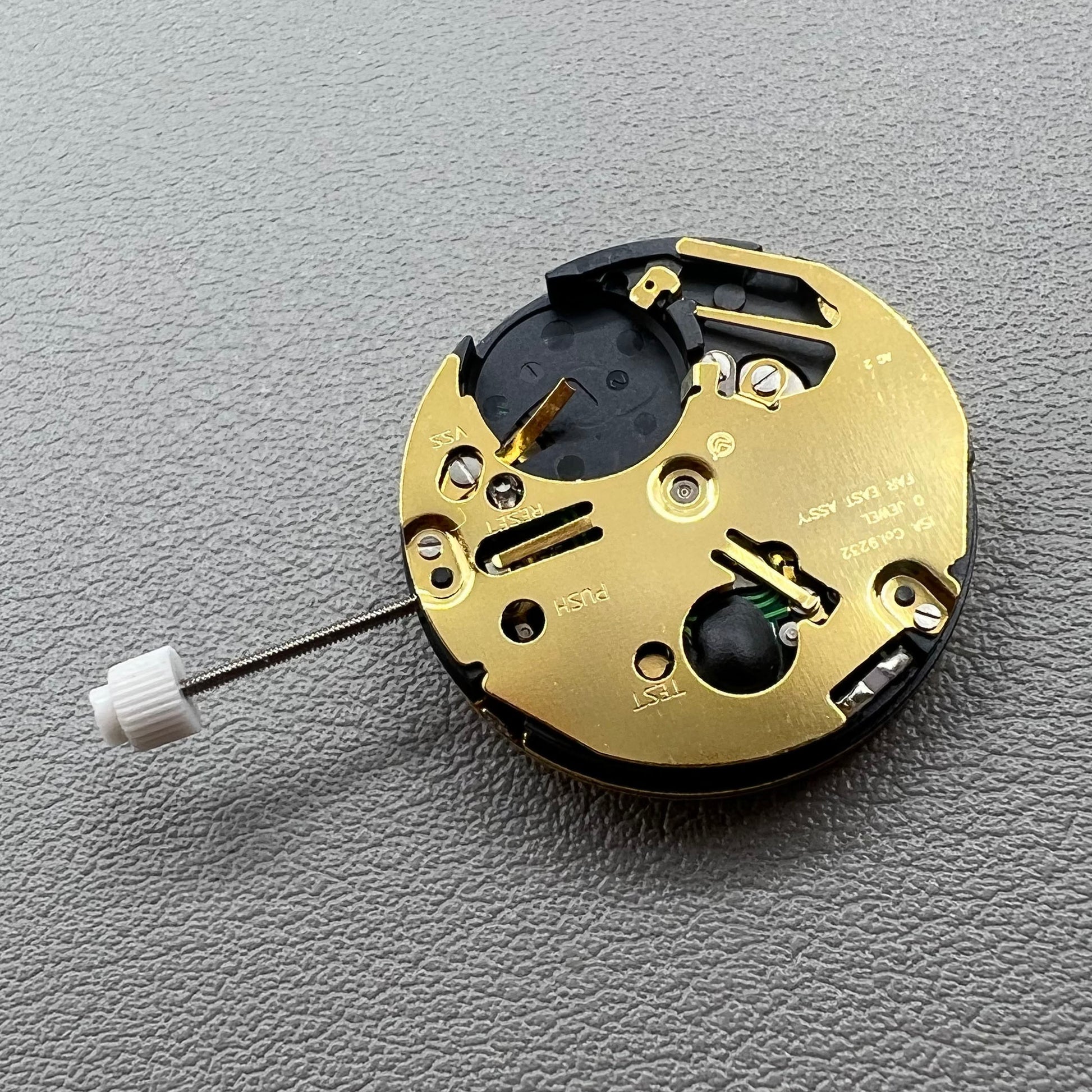 Swiss ISA 9232 quartz watch movement with six hands, date at 3, small seconds at 6/9/12, precision timekeeping.