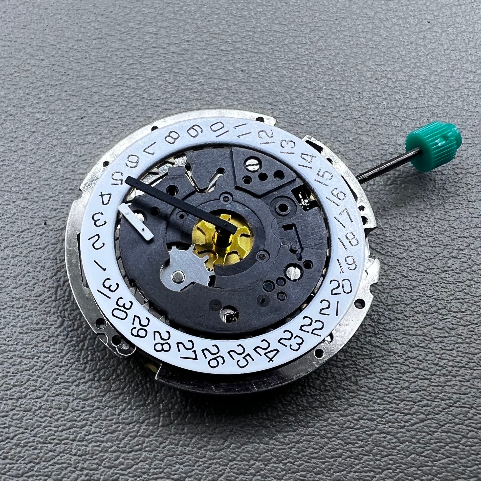 Swiss ISA 8172 silver plated quartz watch movement with stem, precise timekeeping for watch repair and assembly.
