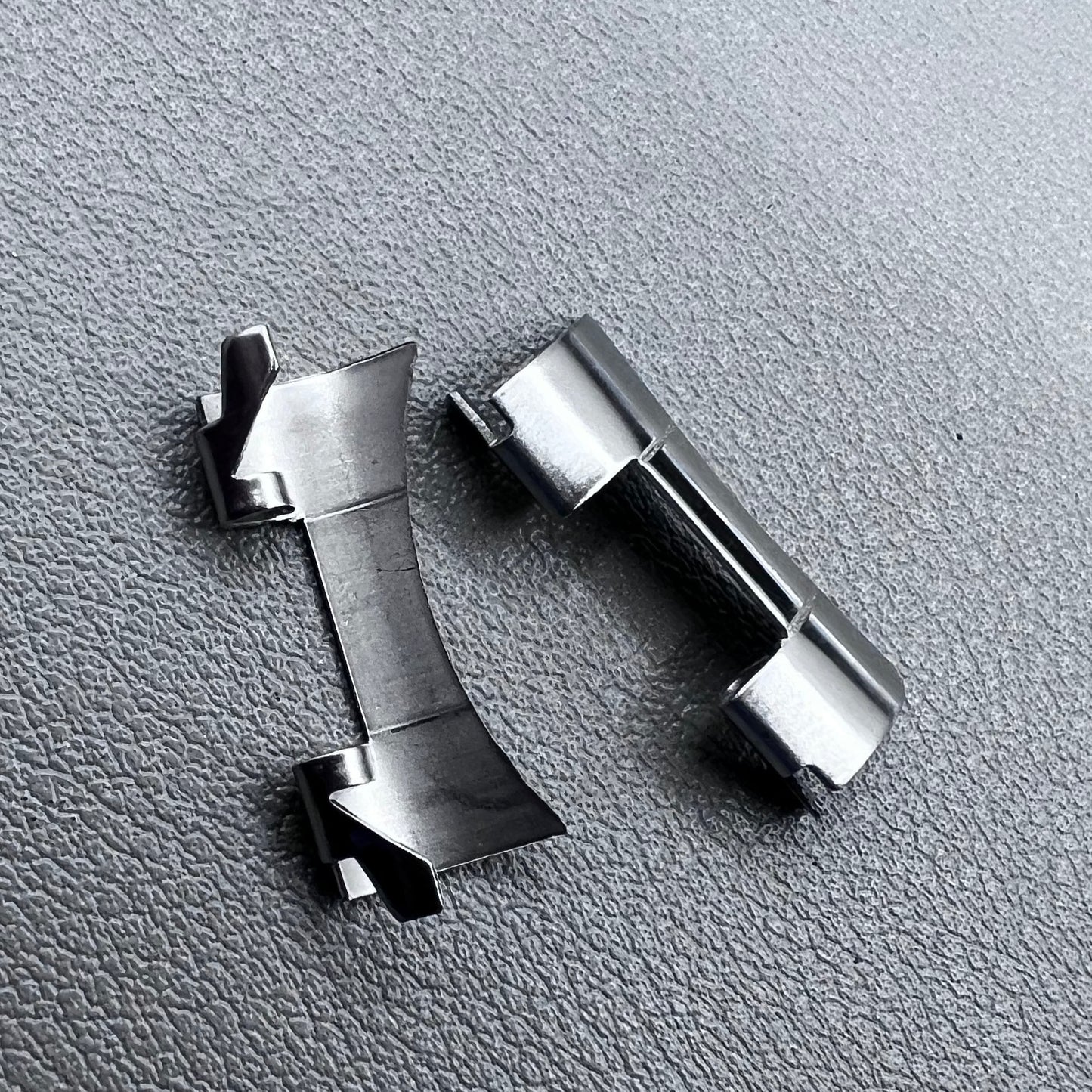 Set of 2 stainless steel 20x9mm curved end links and spring bars for watch bands, compatible with various straps.