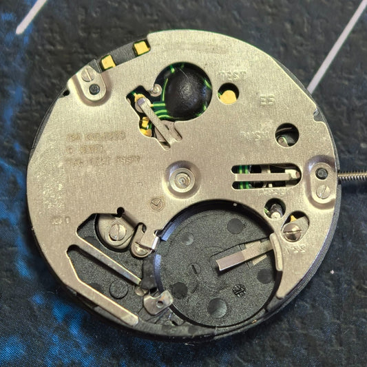 Swiss ISA 2320 quartz watch movement with black dial, orange numerals, date display at 6 o'clock.