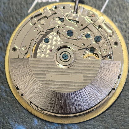 Chinese Dandong 7750 mechanical watch movement showing date at 3 and small seconds at 6, 9, 12 positions.