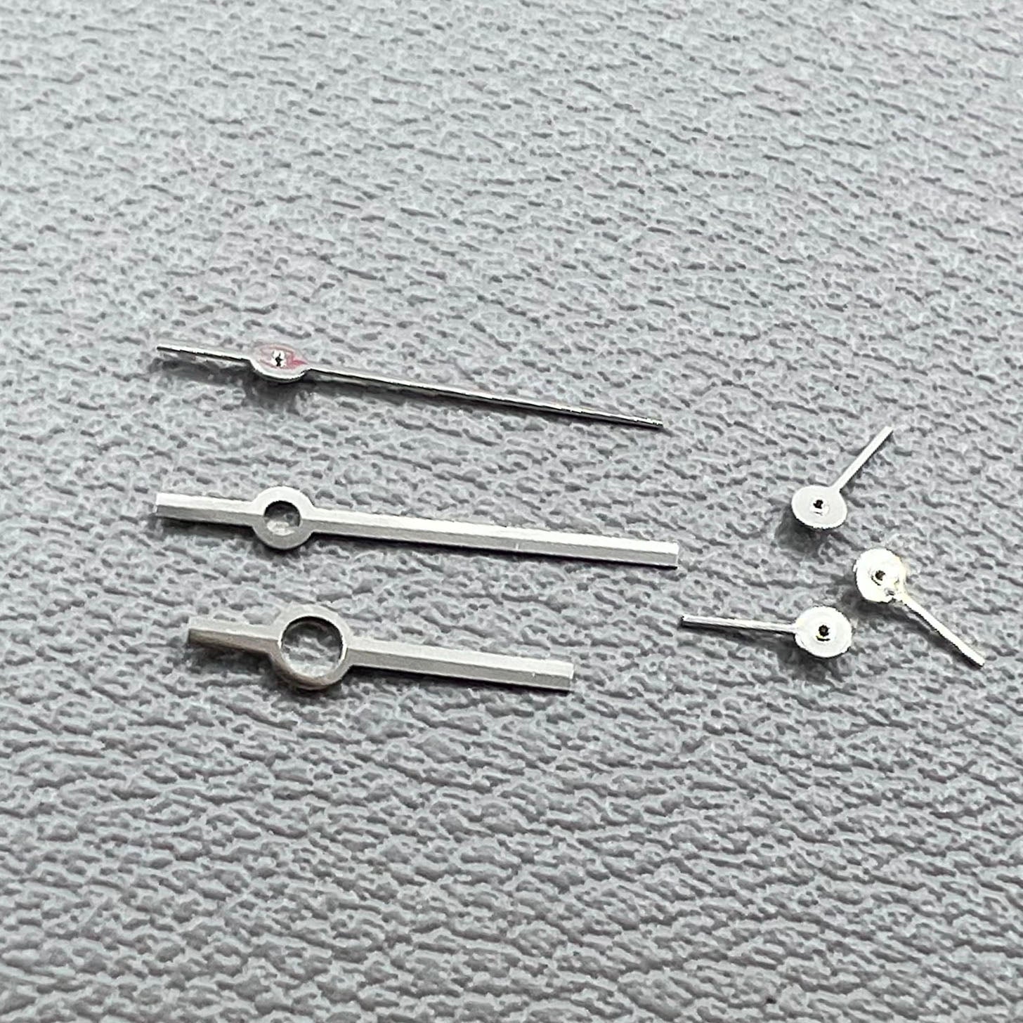 Silver watch hands set for Ronda 5030.D quartz movement, precision timepiece parts.