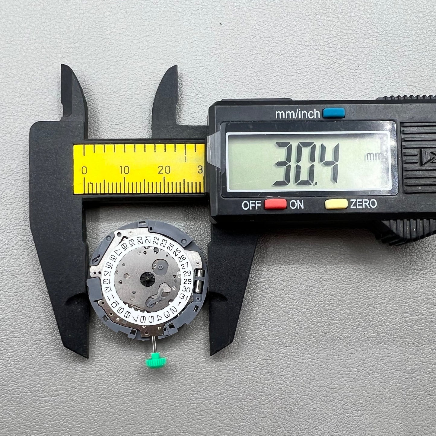 Japan Miyota OS10 quartz watch movement with date display at 3 o'clock, precision timekeeping accessory.