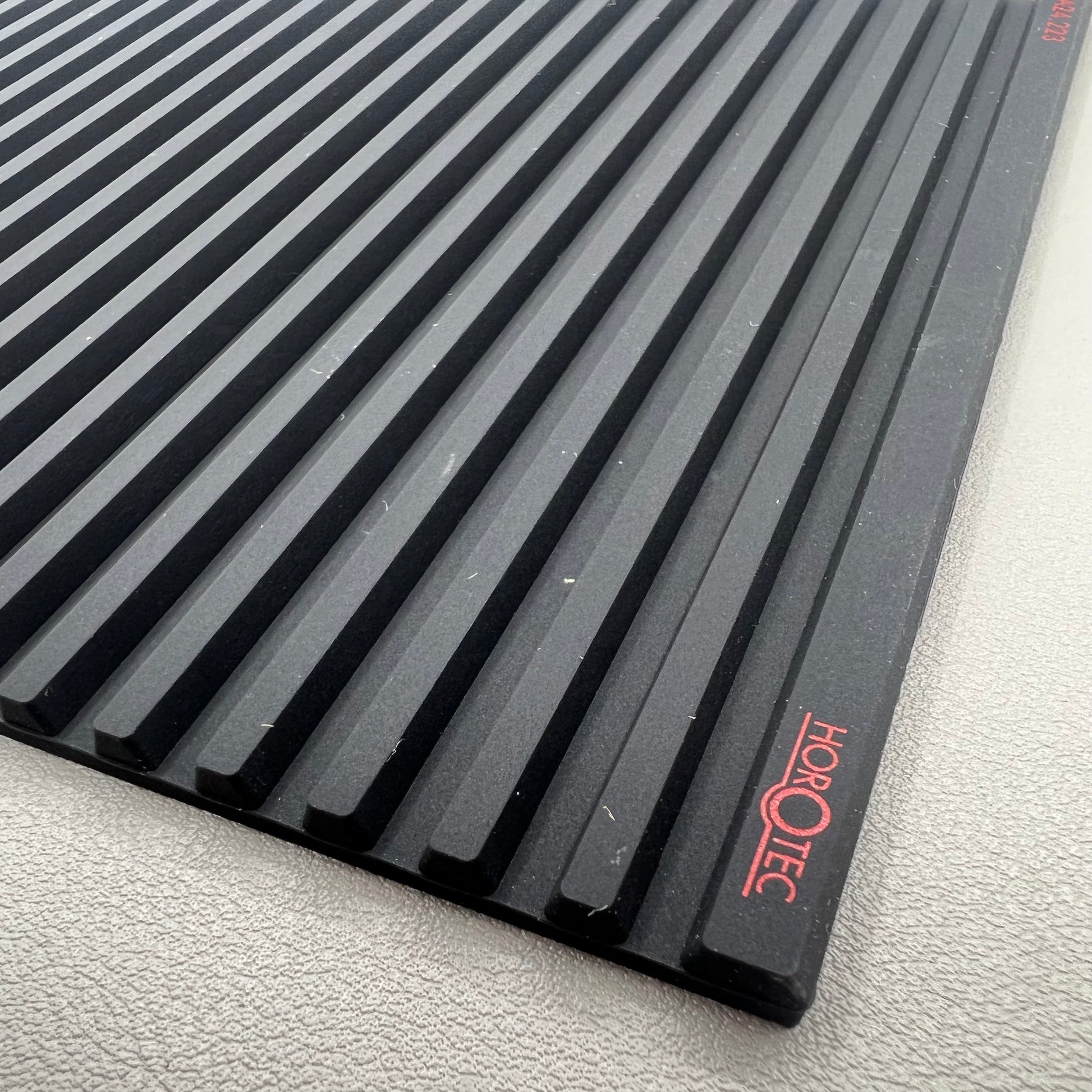 Swiss Horotec black silicon anti-slip bench mat with 32 grooves, ideal for watch repair tools organization.