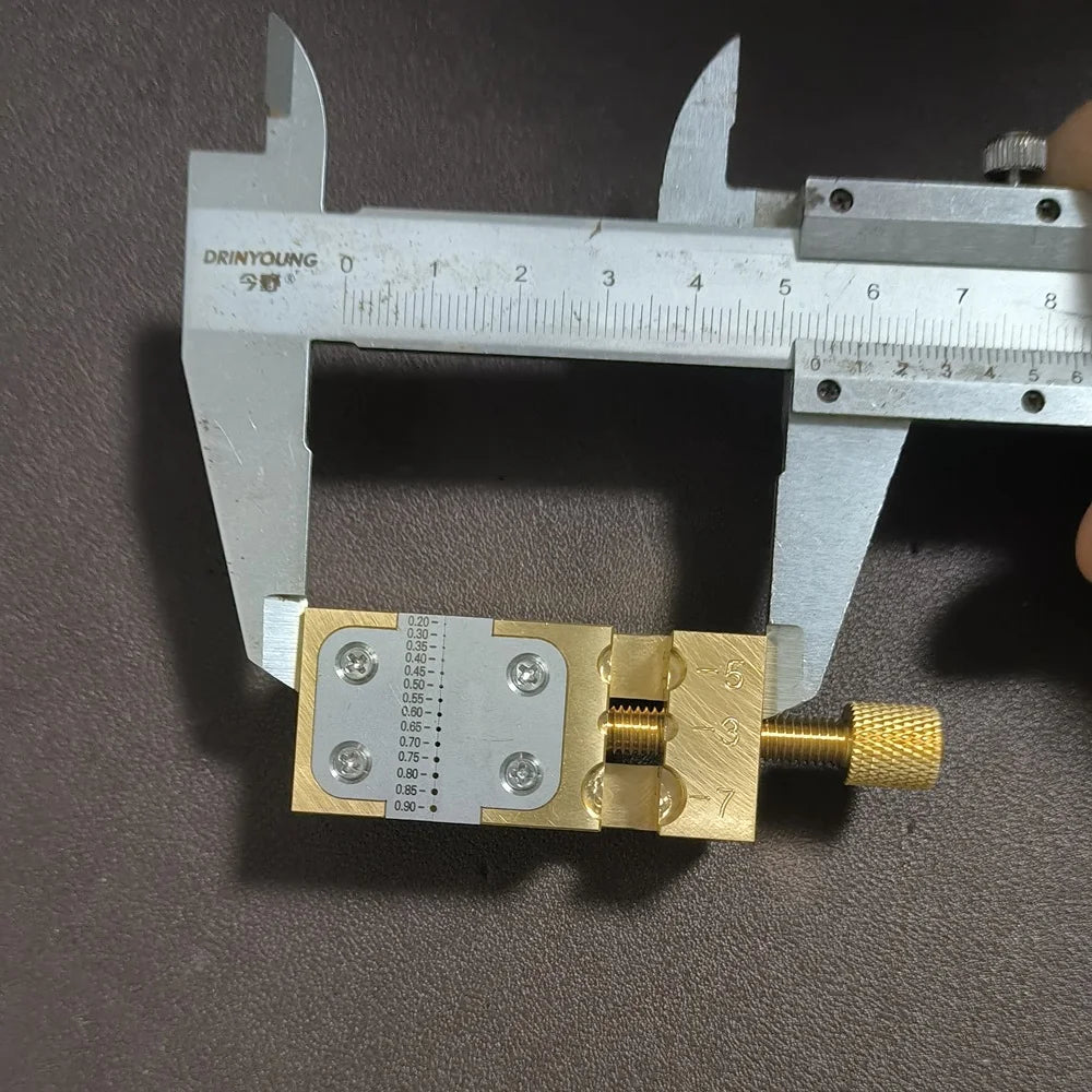 Copper Pointer Tube Clamp manual vise for watch repair on desktop, ideal for precise watch accessory adjustments.