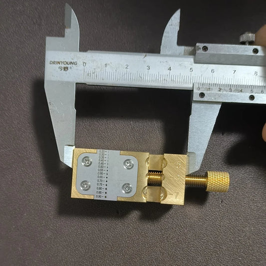 Copper Pointer Tube Clamp manual vise for watch repair on desktop, ideal for precise watch accessory adjustments.