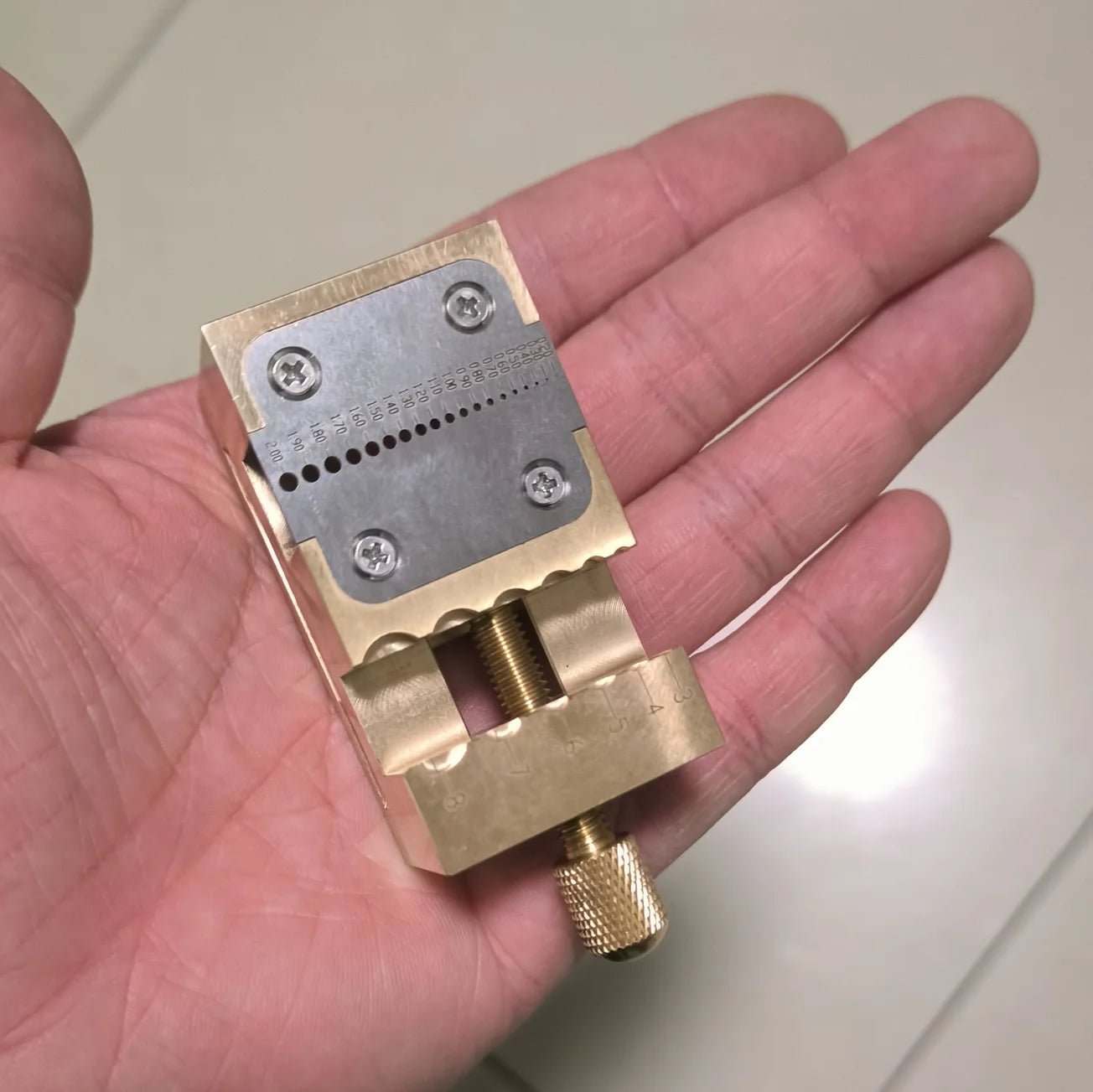 Copper watch repair tool with pointer tube clamp and manual vise for precise desktop watch fixing.