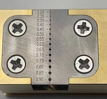 Copper Pointer Tube Clamp manual vise for watch repair on desktop, ideal for precise watch accessory adjustments.