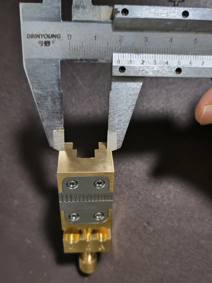 Copper Pointer Tube Clamp manual vise for watch repair on desktop, ideal for precise watch accessory adjustments.