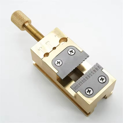 Copper Pointer Tube Clamp manual vise for precise watch repair on desktop, ideal for detailed watch accessory fixes.