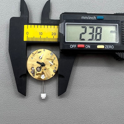 Swiss ISA 9232 quartz watch movement with six hands, date at 3, small seconds at 6/9/12, precision timekeeping.