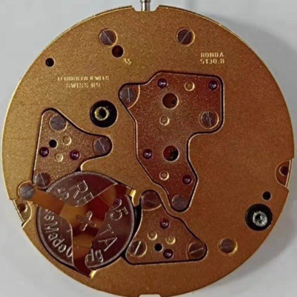 Swiss Made Ronda 5130B quartz movement watch with gold-tone case and date display at 12 o'clock.