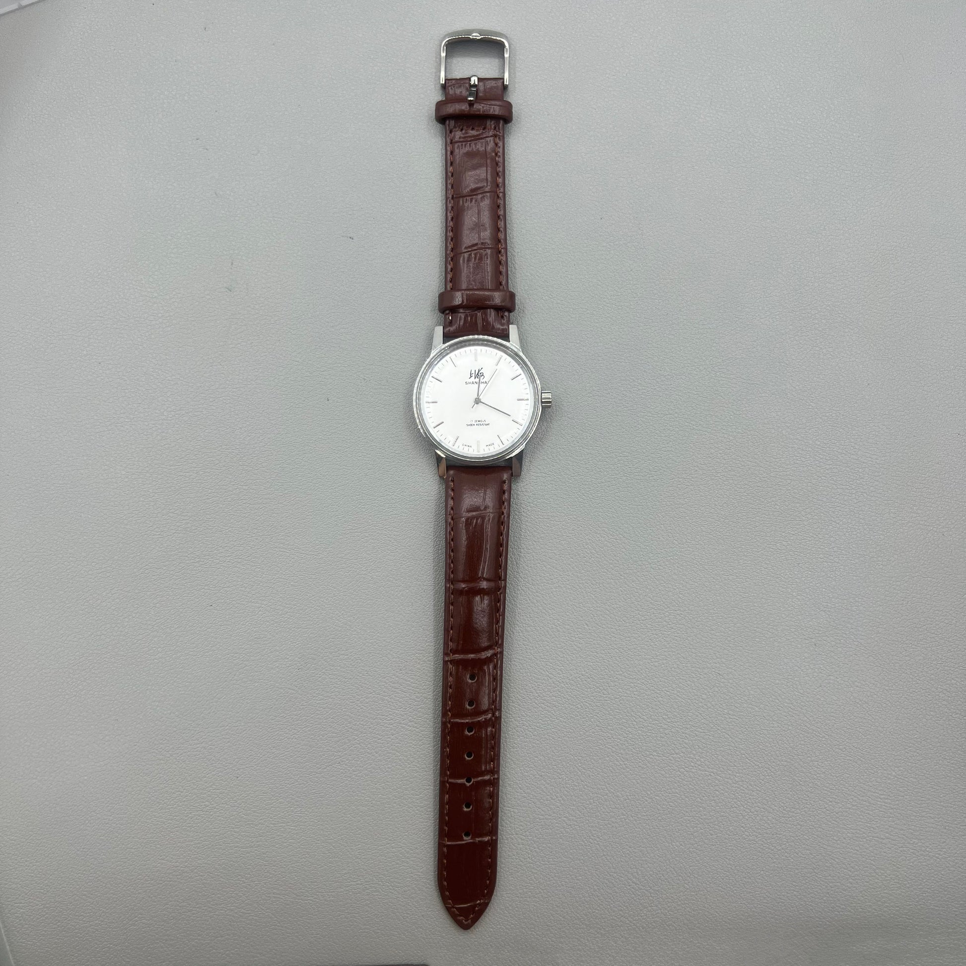 Shanghai 36mm 8120 manual mechanical watch with white dial, brown strap, 17 jewels precision craftsmanship.
