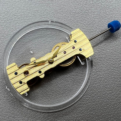 Golden Long Hand winding watch movement showcasing intricate mechanical craftsmanship.