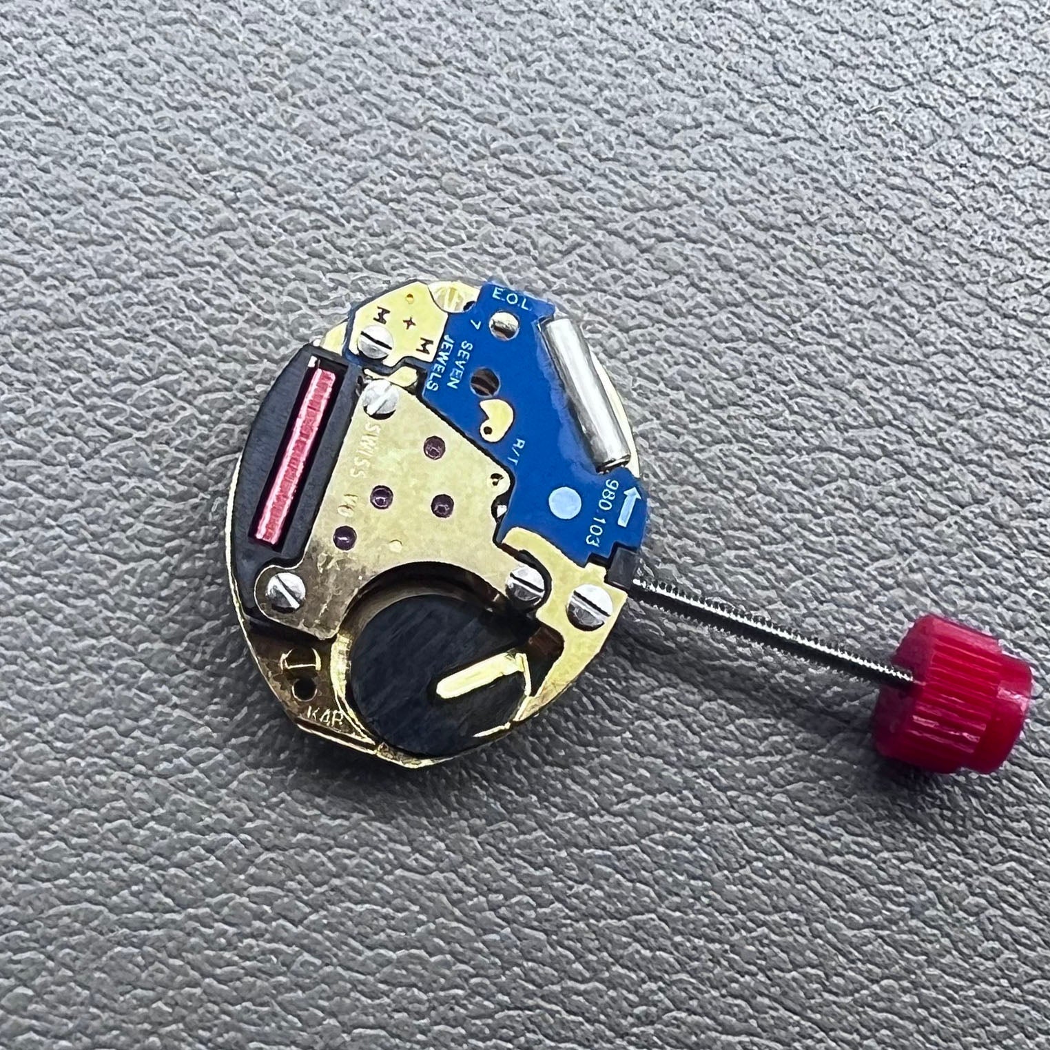 Close-up of Swiss ETA 980.103 quartz watch movement showcasing precision engineering and reliability.