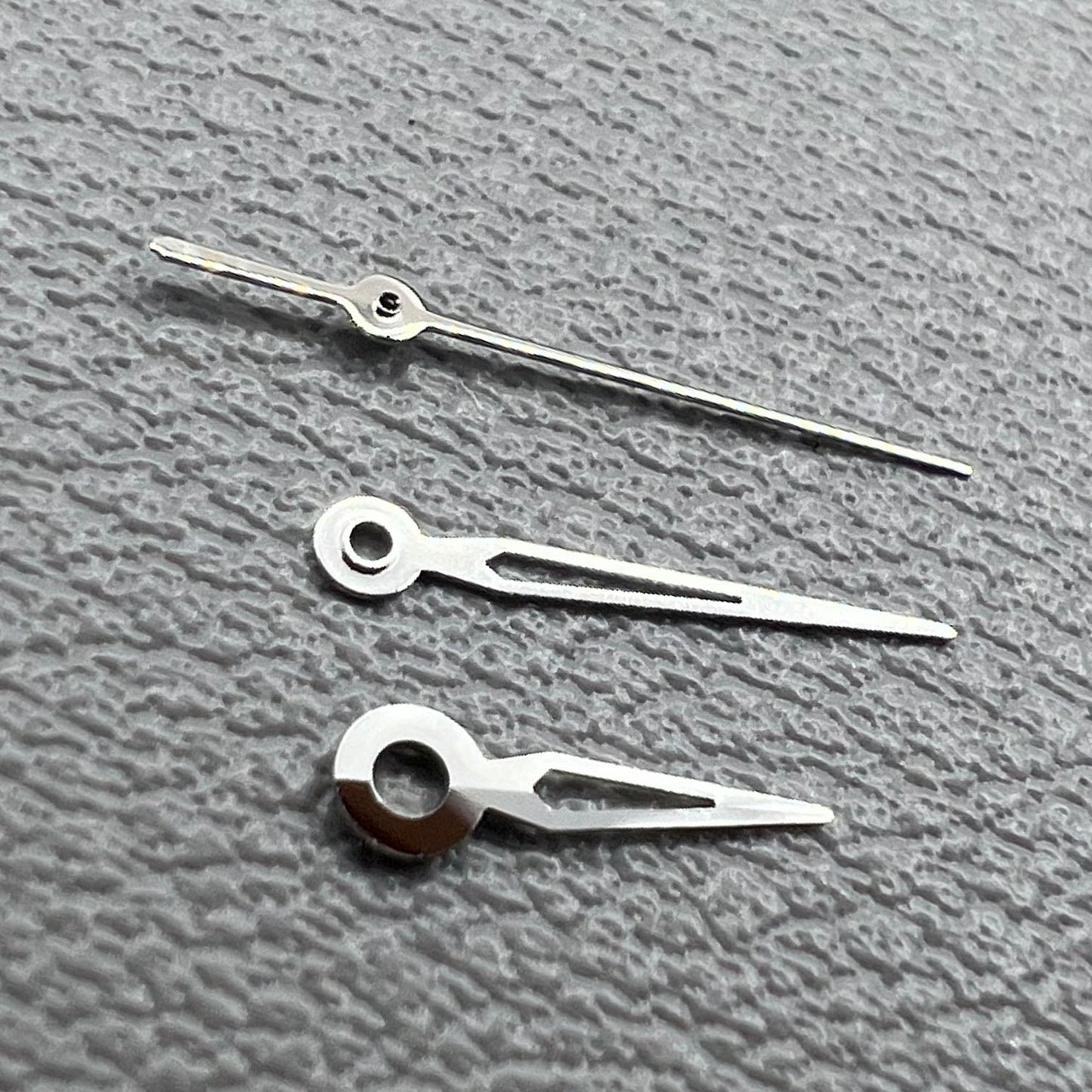 Hollow silver trim watch hands set for NH05 NH06 movement, compatible with watch repairs and customization.