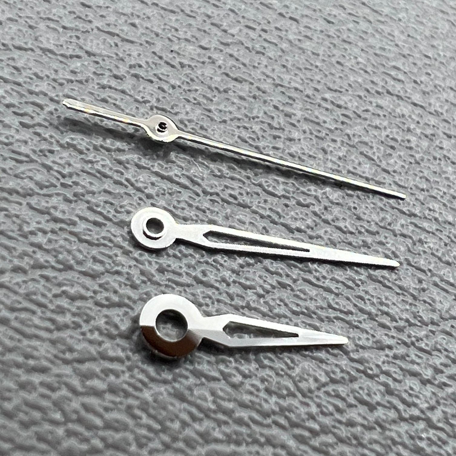 Hollow silver trim watch hands set for NH05 NH06 movement, compatible with watch repairs and customization.