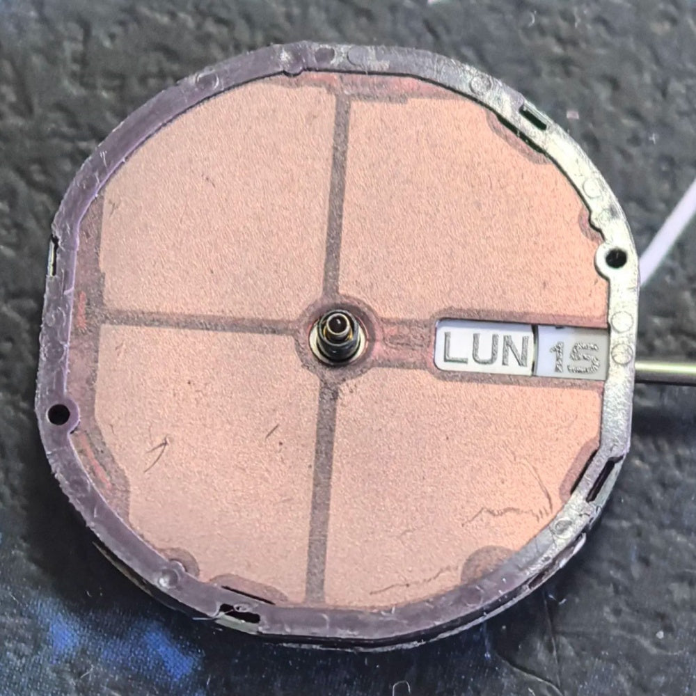 Citizen Eco-Drive E001 quartz watch movement showing solar-powered day and date display at 3 o?clock.