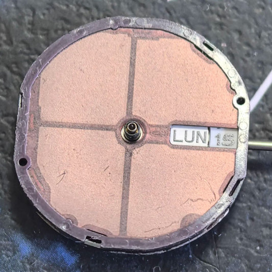 Citizen Eco-Drive E001 quartz watch movement showing solar-powered day and date display at 3 o?clock.