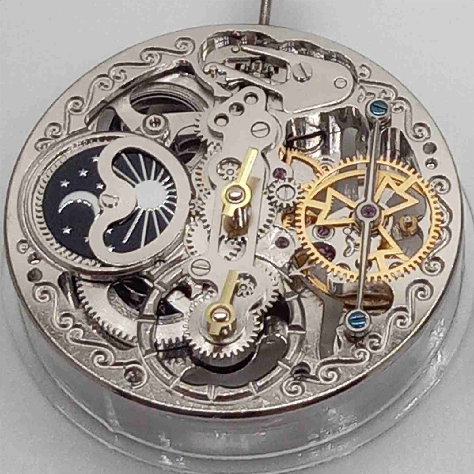 Silver hollow balance wheel with double mainspring, precise movement at 6 o'clock, ideal watch accessory.