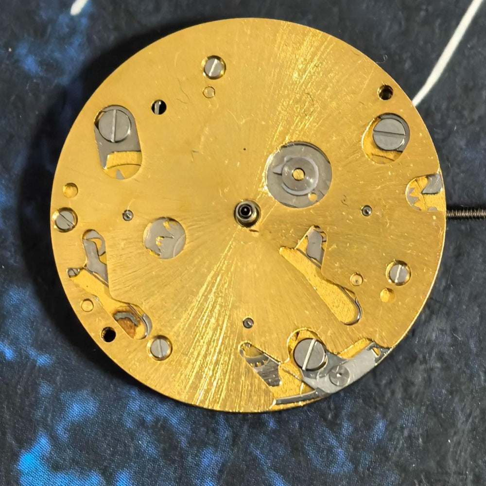 Swiss ISA9238 golden multifunctional quartz watch part with six hands for precise timekeeping.